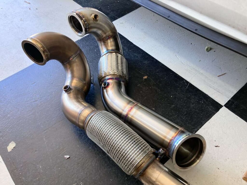 CC Design 4" Downpipe (R) and Trackslag 3" Downpipe (L)